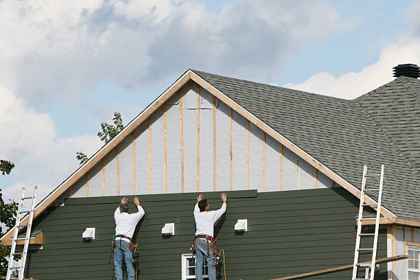 Professional Storm Damage Siding Repair technician working in Sharpes, FL